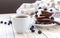 Hot coffee and buckwheat chocolate pancakes with blueberries