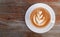 Hot coffee cappuccino latte art top view on wooden background