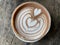 Hot coffee cup with art froth milk heart  on top