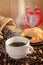 Hot coffee cup and breakfast baked croissants and red clock mark on 6 o`clock