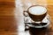 Hot coffee cup on the wooden table, underexposure