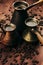 Hot coffee in group shabby antique turkish pots cezve with crem, beans with blur on brown old wooden board background, vertical sh