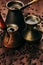 Hot coffee in group shabby antique turkish pots cezve with crema, beans with blur on brown old wooden board background, vertical s
