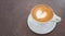 Hot coffee latte art heart shape foam on leather background
