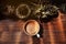 Hot Coffee Latte Cup on Wooden Table under with Natural Light. Top View. Surrounded by mini Cactus Tree Pot