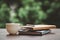 Hot coffee, smoke, with books and pens for note taking with beautiful nature background