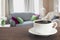 Hot coffee on tabletop in modern living room with chair, soft divan