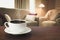 Hot coffee on tabletop in modern living room in rustic style with chair, soft divan.