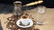 Hot coffee in Turkish Cooper and linen table. Greek Coffee Pot, Glass of water and Coffee beans dropped on wooden table.