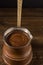 Hot coffee in Turkish copper pot