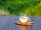 Hot coffee on wooden saucer and on wooden table