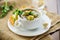 Hot cooked soup with Brussels sprouts, vegetables and croutons, in a plate