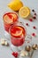 Hot cranberry tea or detox winter drink - sangria with fresh lemons in glasses on the gray concrete background