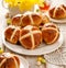 Hot cross buns, freshly baked hot cross buns on a white plate, close-up.
