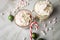 Hot dark chocolate during holiday season with whipped cream, marshmallows, candy canes, Christmas tree ornaments, green glitter
