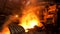 Hot dark workshop of steel production in electric furnaces, with burning fire and smoke. Stock footage. Metallurgical