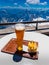 Hot dog with german beer with view of alps mountain range