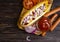 Hot dog gourmet picnic board a wooden background traditional sauce ingredients