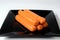 Hot dog sausages on black plate on a white background