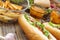 Hot dogs, Different snacks and beer on a wooden table, close-up. National Day hot dog USA