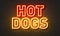 Hot dogs neon sign on brick wall background.