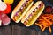 Hot dogs with onions, relish, mustard and ketchup served with fries, close up, top view table scene