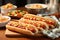 hot dogs on a plate alongside piles of fresh buns