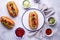 Hot dogs with sausage, sauces and vegetables