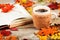 Hot drink in a large cup, book, colorful autumn leaves