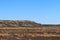 Hot and dusty Outback landscape with black pebbles and rolling slopes