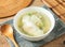 Hot egg Omelette Soup in a white bowl with wooden spoon isolated on mat top view