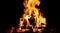 Hot fireplace full of wood. Real Flames from burning logs texture background. Fireplace background. Fire flame close up