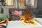 Hot flaming iron on ironing board. In defocused background woman is sleeping on sofa. Copy space. Concept of fire hazard