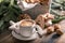 Hot flavored nutty cappuccino with caramel and gingerbread Christmas cookies on a rustic table. Homemade sweet pastries