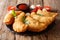 Hot fried panzerotti with a filling of tomatoes, herbs and mozza