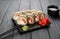 Hot fried sushi roll with salmon on black background. Sushi menu. Japanese food