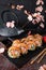 Hot fried Sushi Roll with salmon, shrimp, onion, avocado and cheese. Sushi menu.