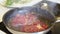 in a hot frying pan fry pieces of meat with garlic and rosemary. cooking steaks.