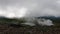 Hot gas and steam from fumaroles on slope of Mt. Asahi with low clouds