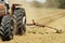 Hot heat summer sun ploughing fields in Kwazulu Natal South Africa, dusty movement blur, tractors, machinery