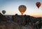 Hot iar balloons flying above rocks