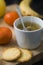 Hot infusion with tangerines and butter cookies over wooden table