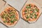 Hot Italian pizzas with arugula in cardboard boxes