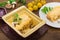 Hot Julienne with juicy chicken, mushrooms, cream sauce and cheese. Meat appetizer. Wooden background. Top view. Close-up