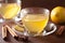 Hot lemon ginger cinnamon tea in glass cup