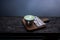 Hot Matcha Green tea Latte in white cup on wood board above wooden porch with river behind