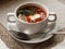 Hot meat Russian traditional tomato soup saltwort Solyanka on white bowl on natural linen background