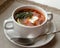 Hot meat Russian traditional tomato soup saltwort Solyanka on white bowl on natural linen background