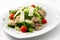 Hot meat salad with sesame seeds, cherry tomatoes and arugula