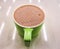 Hot milk cocoa with sweet foam in mint green mug